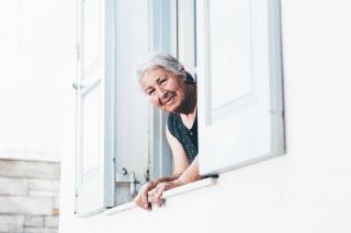 Photo of elderly woman at window